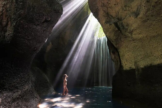 Ubud Waterfalls and Rice Terraces Private Day Tour - Kanto Lampo: water over dark rock